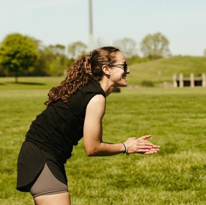 Coach encouraging members during an outdoor team workout